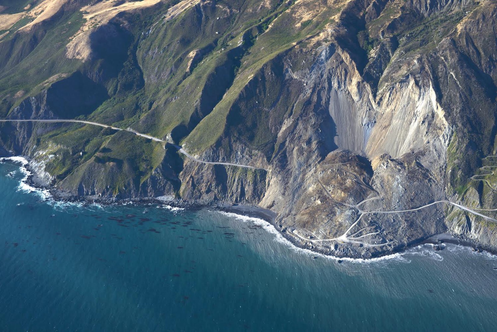 Aerial view of coastal terrain and a winding road at Big Sur, California